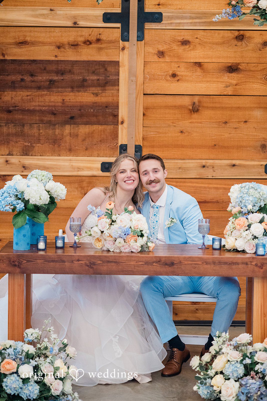 Aubrey + Casey The newlyweds sit together at the decorated table, celebrating their special day.