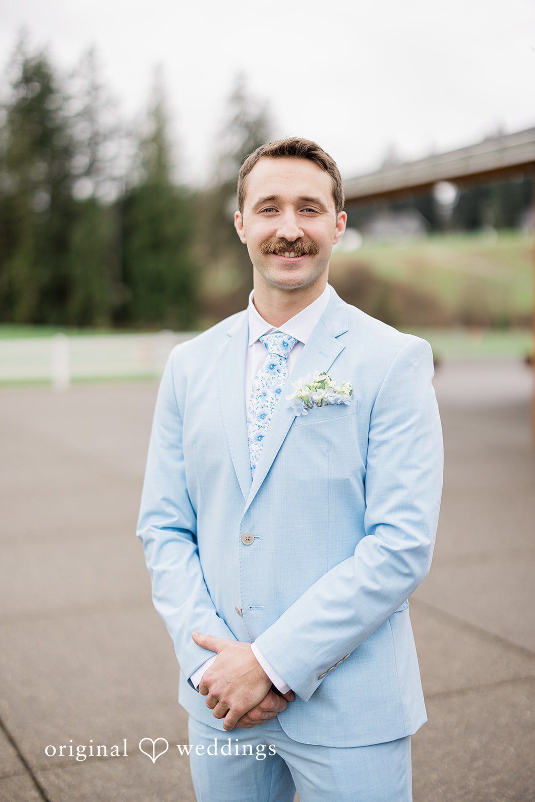 Aubrey + Casey The groom poses confidently in his light blue suit before the ceremony.