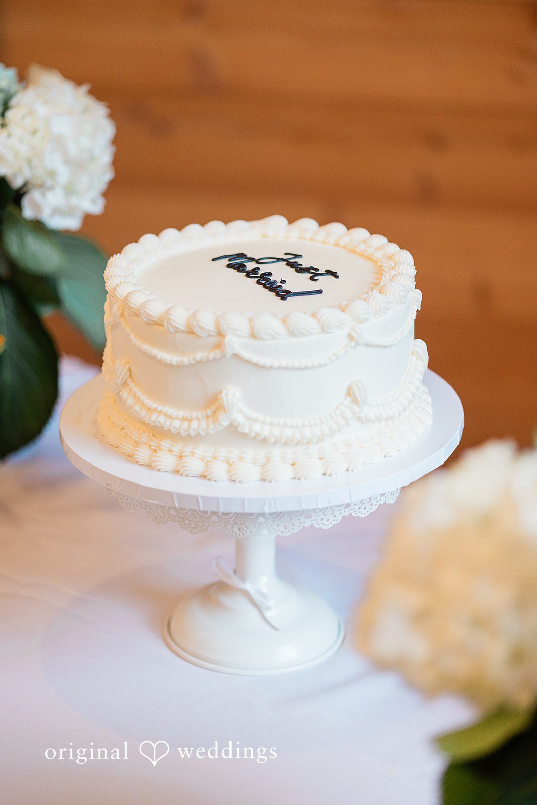 Aubrey + Casey A beautifully decorated wedding cake sits elegantly on display.