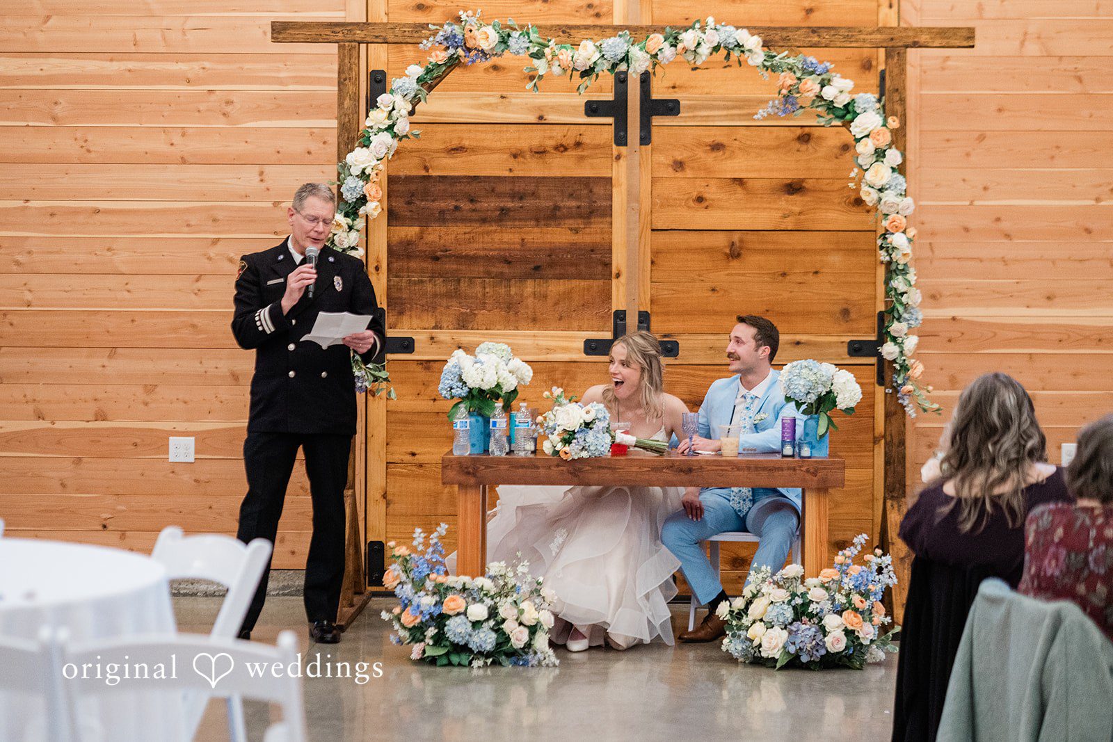 Aubrey + Casey A speech is given while the couple sits at the head table during the reception.
