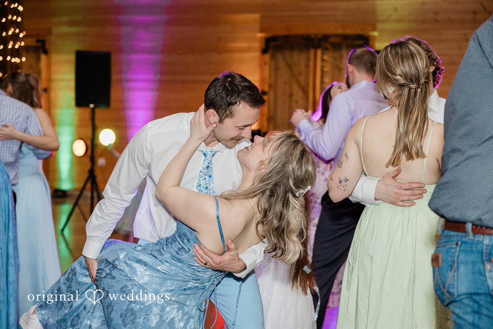 Aubrey + Casey The couple shares a romantic dance surrounded by guests on the dance floor.