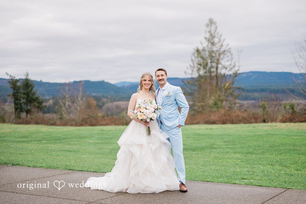 Aubrey + Casey The couple stands together outdoors, posing with a scenic mountain view, capturing the essence of Seattle wedding photography.