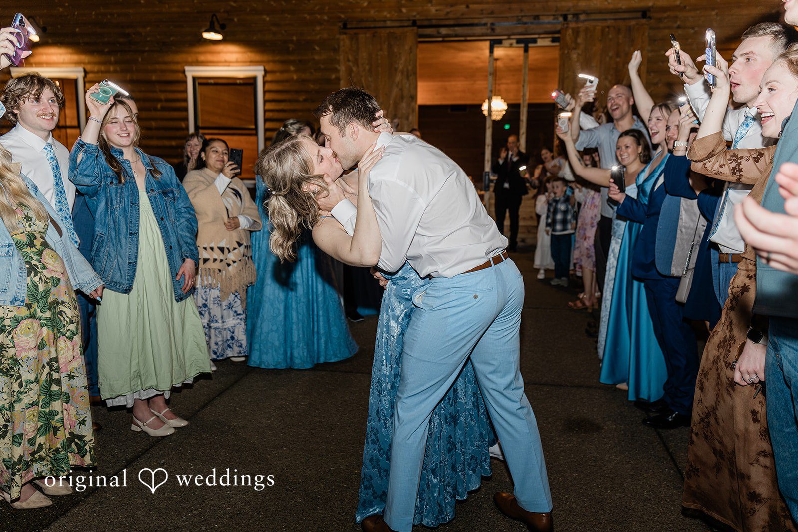 Aubrey + Casey The bride and groom share a kiss on the dance floor surrounded by cheering guests.