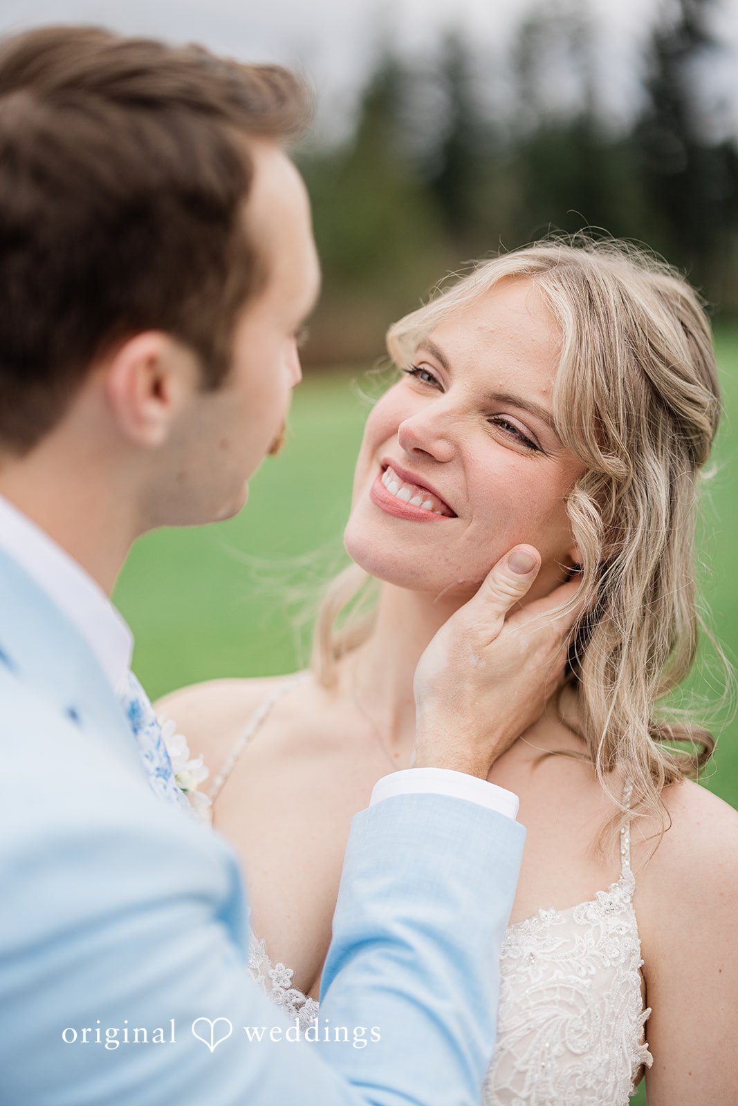 Aubrey + Casey The groom gently touches the bride’s face as she smiles with joy.