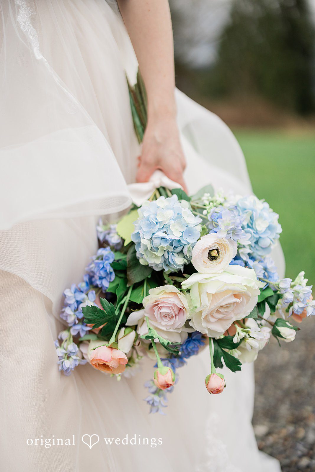 Aubrey + Casey A close-up of a colorful bridal bouquet held gently by the bride.