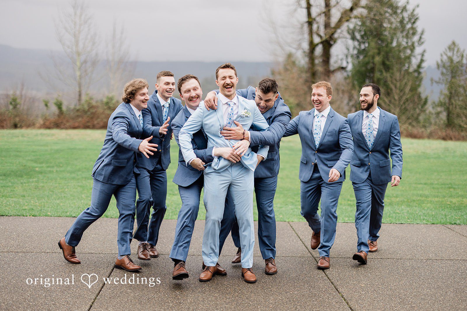 Aubrey + Casey The groomsmen walk together outdoors, laughing and enjoying the moment.