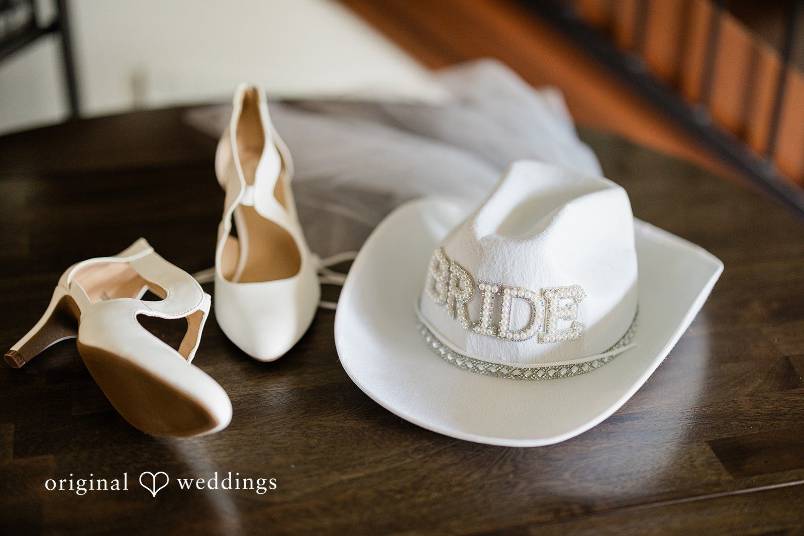 Aubrey + Casey Bridal accessories including shoes and a “bride” hat are arranged stylishly.