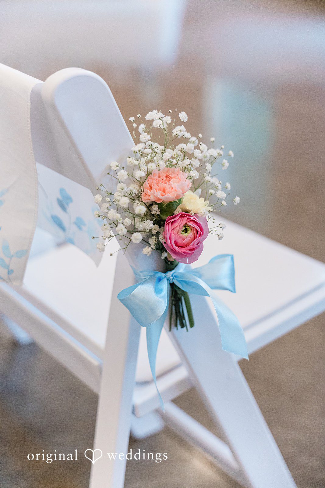 Aubrey + Casey A delicate bridal bouquet rests elegantly on a decorated ceremony chair.