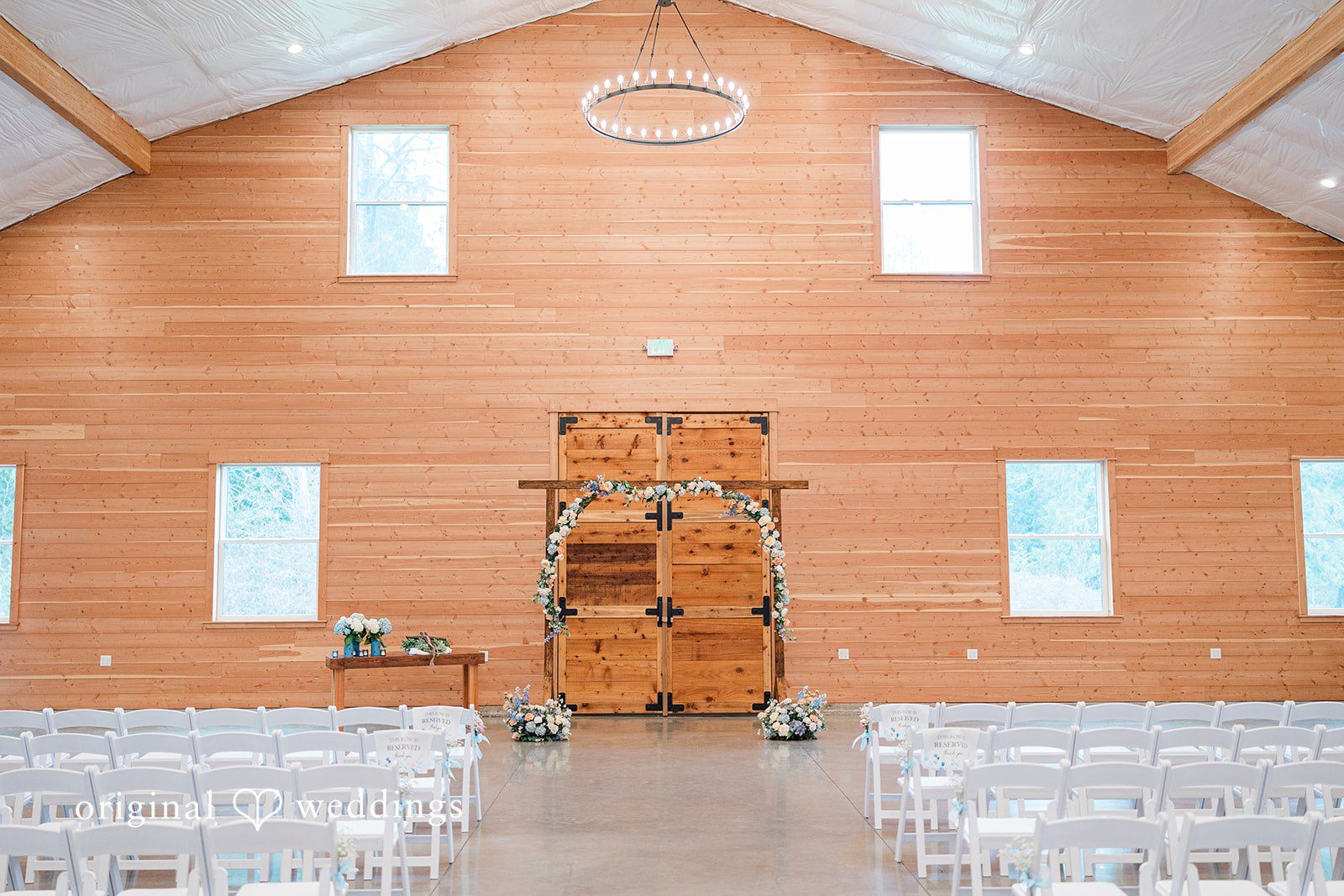 Aubrey + Casey The ceremony space is set up inside a wooden chapel, ready for guests.