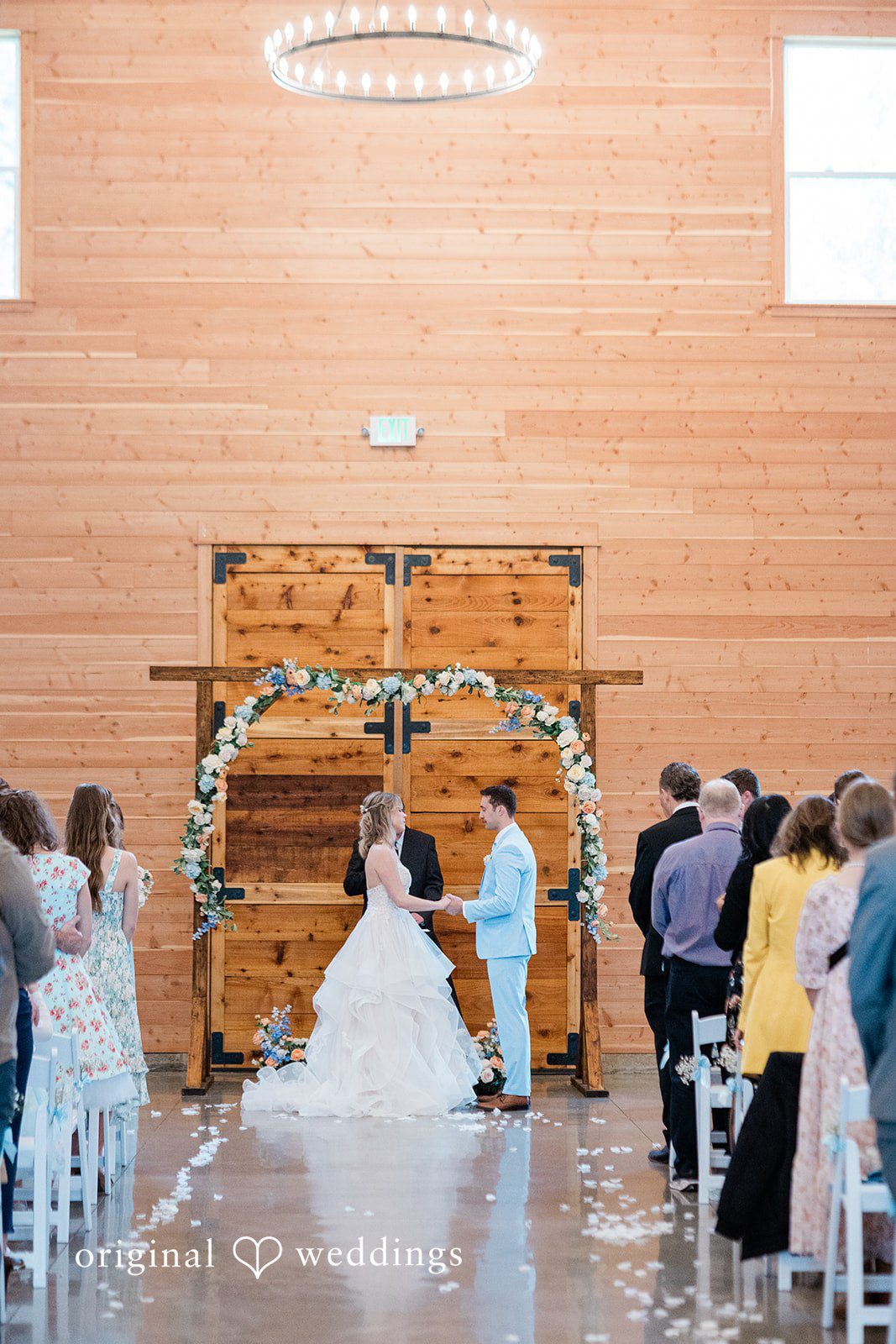 Aubrey + Casey The couple stands at the altar during their ceremony as guests watch attentively.