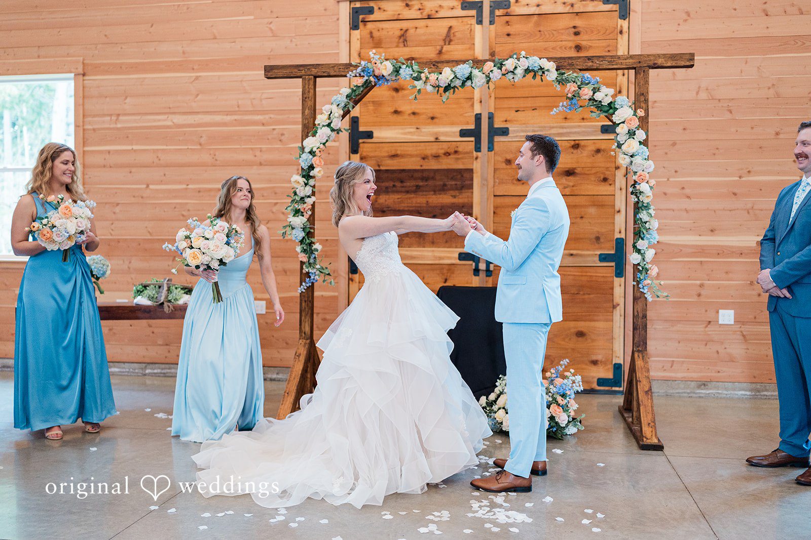 Aubrey + Casey The couple exchanges vows under a floral arch during their romantic ceremony.