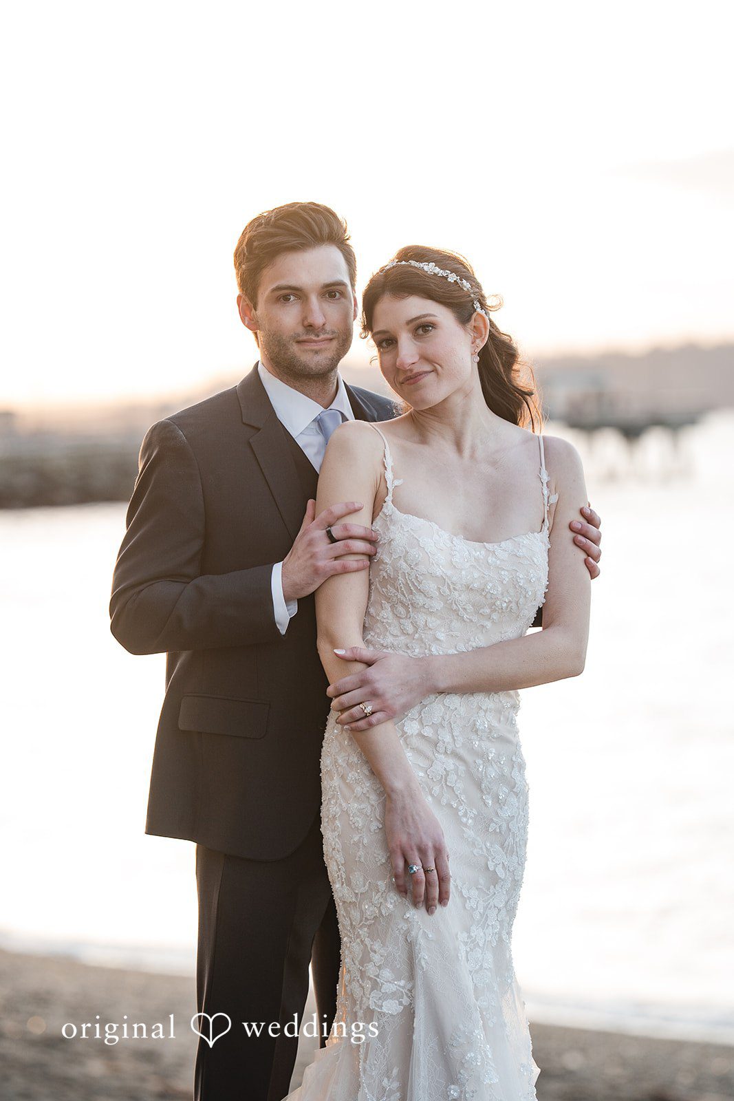 Kelsey + Jensen Original Weddings capturing loving back-hug pose of couple at Edmonds Waterfront Center