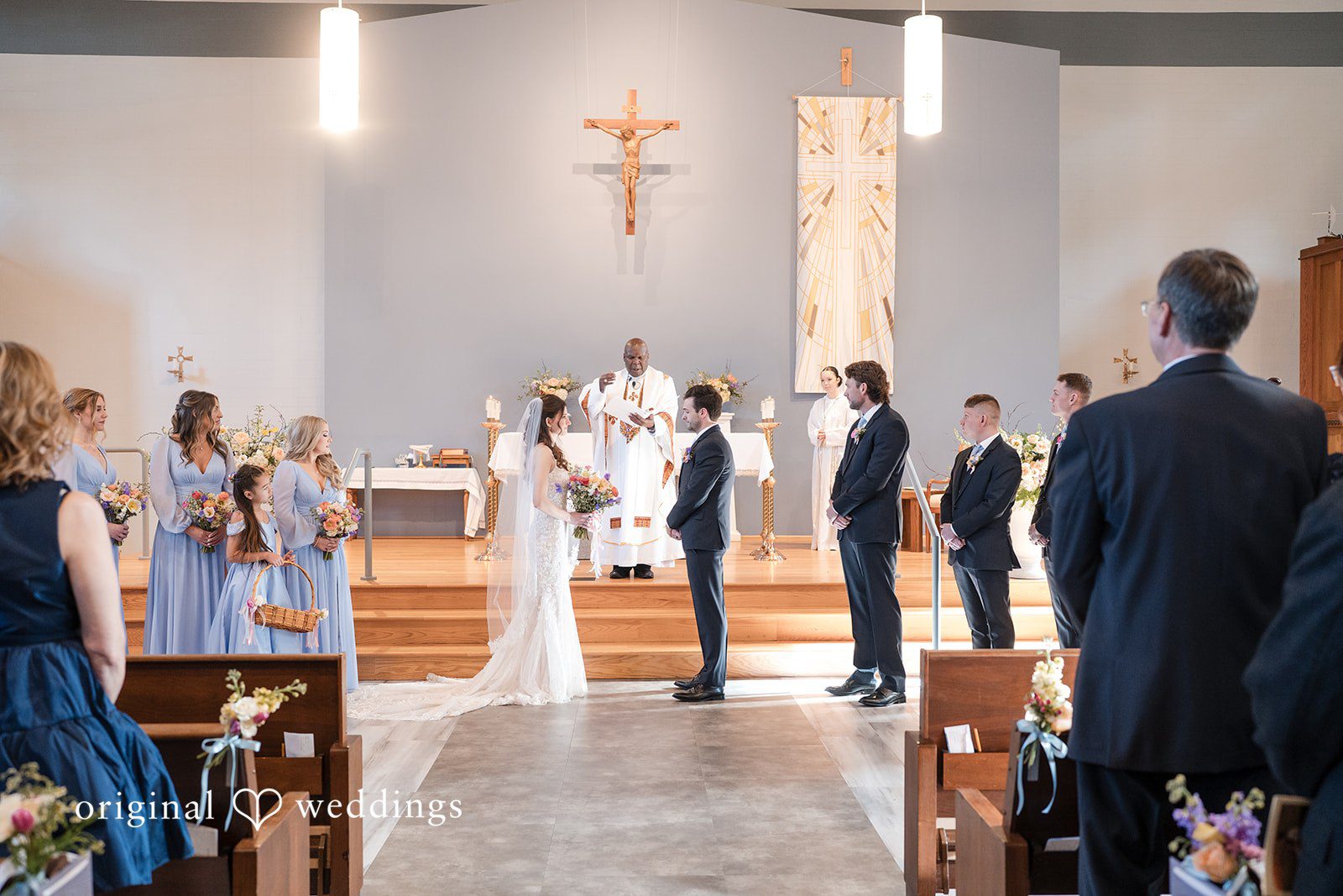 Kelsey + Jensen Seattle Wedding Photographer capturing couple standing in front of priest at Edmonds Waterfront Center by Original Weddings