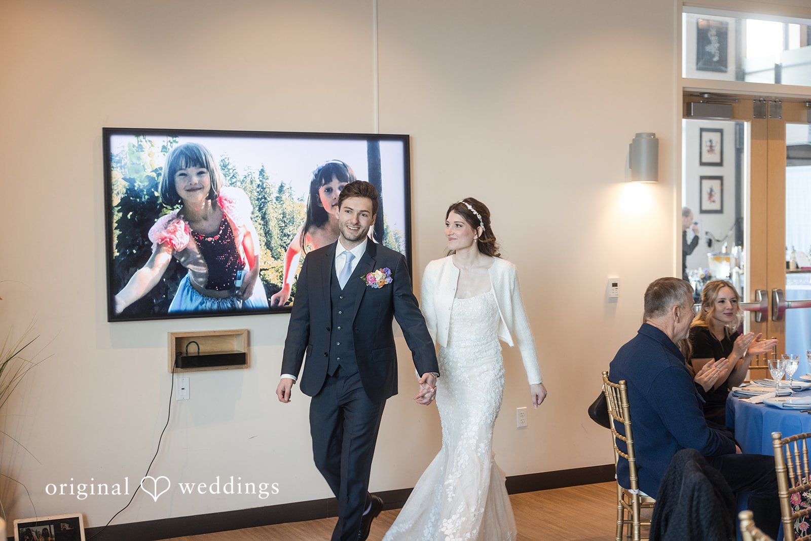 Kelsey + Jensen Seattle Wedding Photographer capturing couple entering for celebration at Edmonds Waterfront Center by Original Weddings