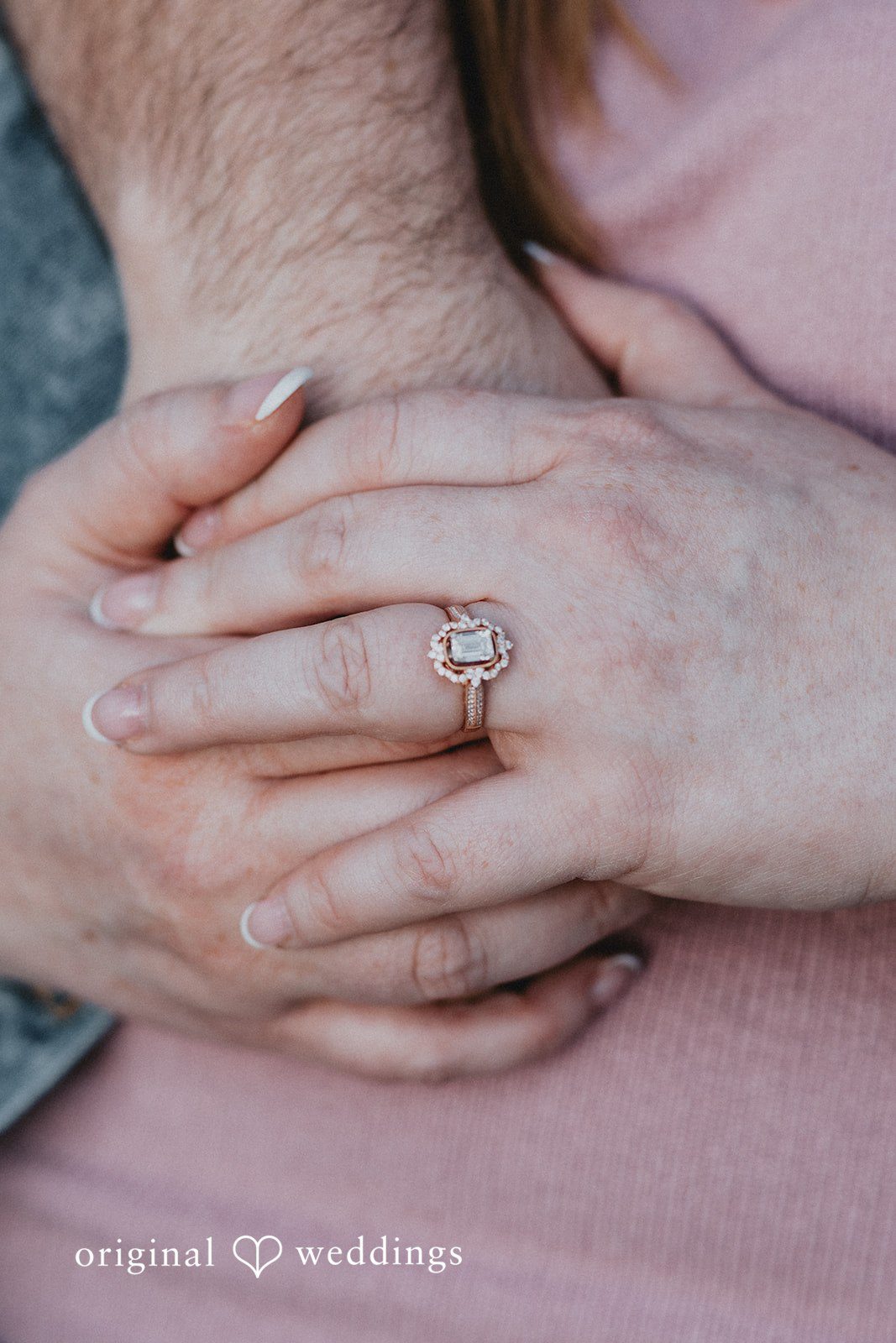 Engagement photography services by original weddings capturing bride and groom showcasing engagement ring while holding hands.