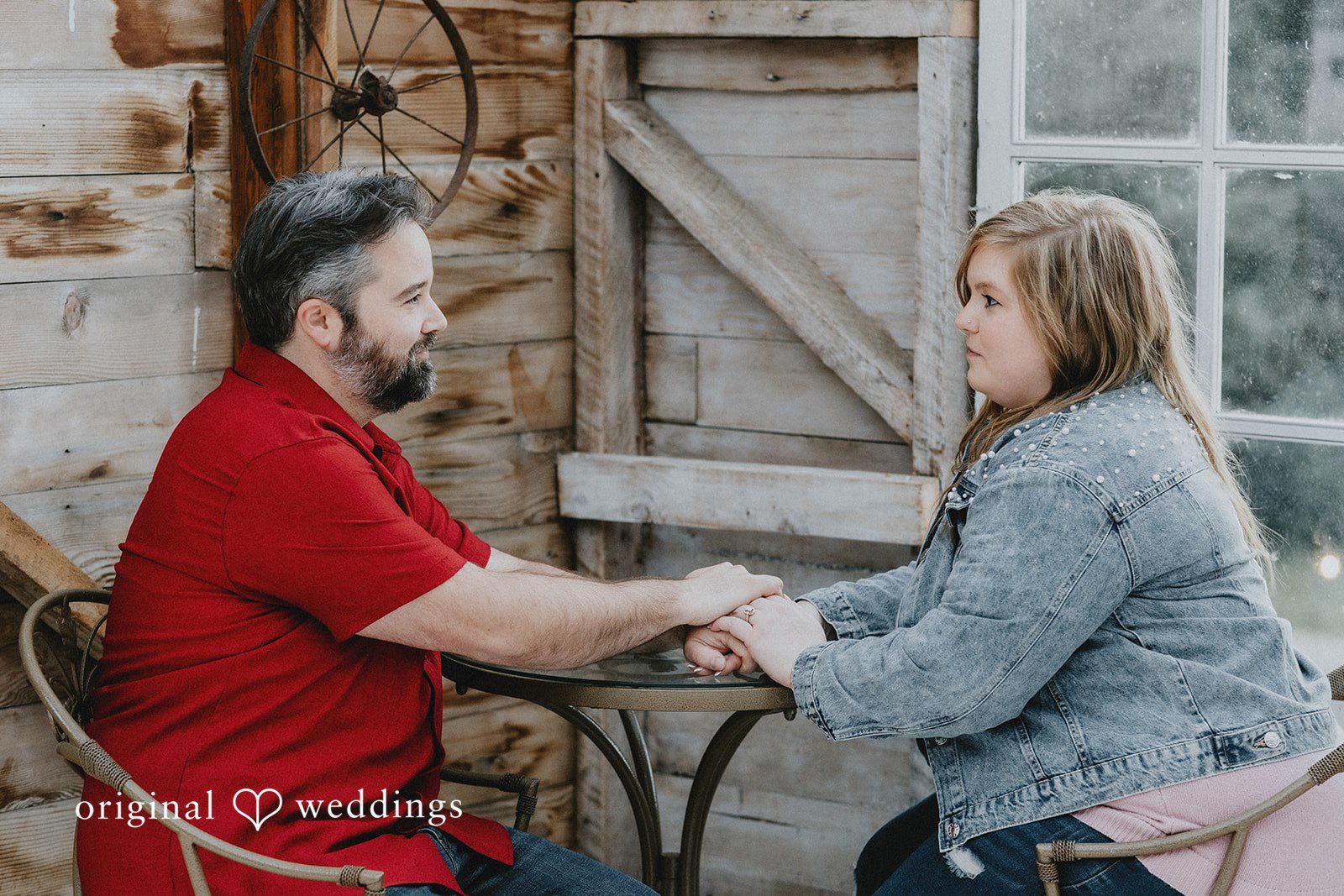 Engagement photography services by Original Weddings capturing couple holding hands and looking at each other at Hidden Farm & Stables
