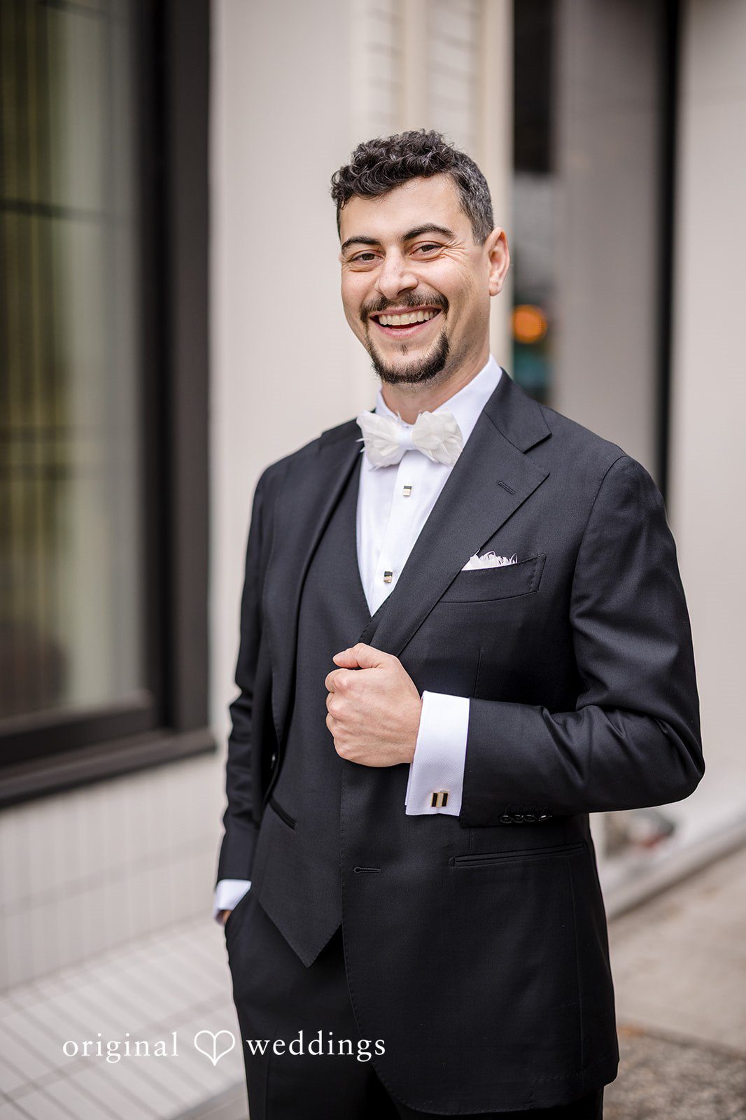 Patrick + Barbara Jean Groom posing confidently in a tuxedo outdoors.