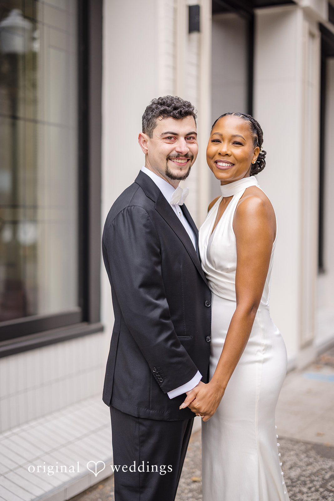 Patrick + Barbara Jean Bride and groom posing together outside on their wedding day.