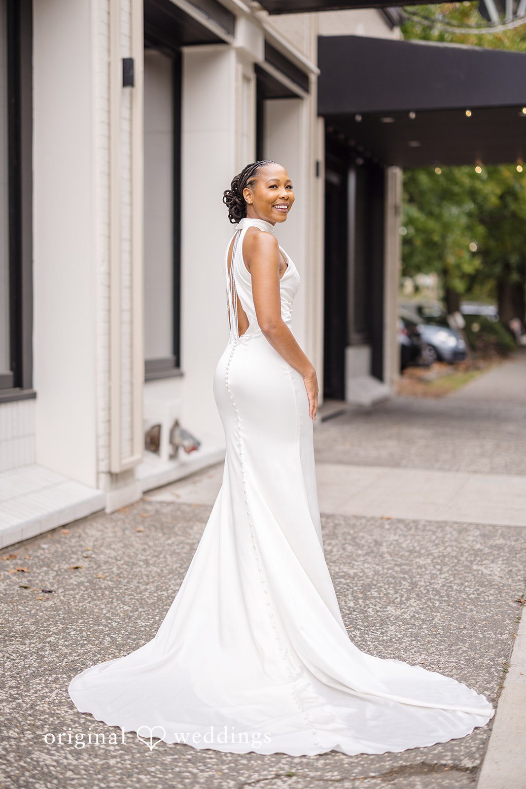 Patrick + Barbara Jean Bride walking outside in her wedding dress with a long train.
