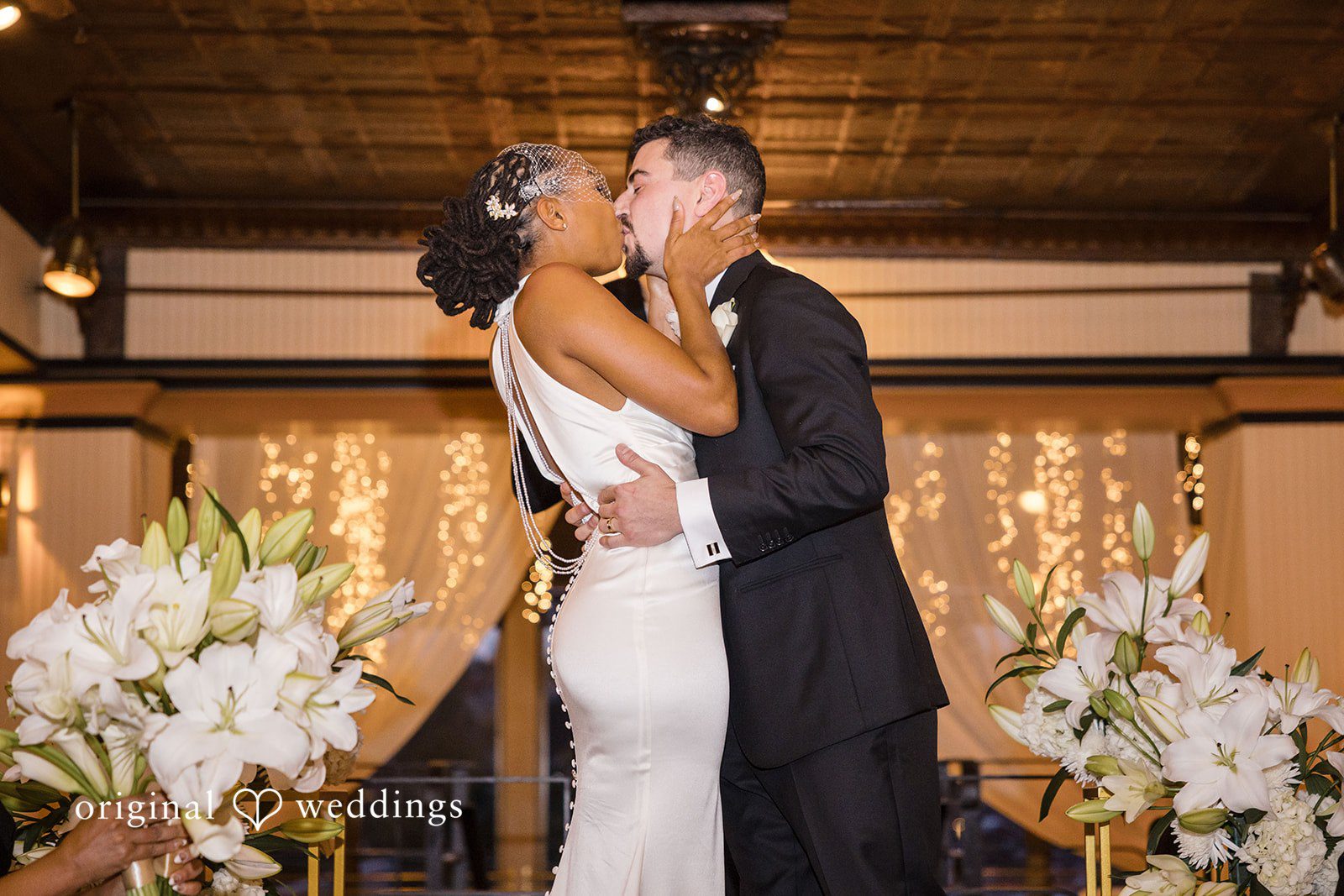 Patrick + Barbara Jean Bride and groom embracing each other in a floral-decorated wedding setting.