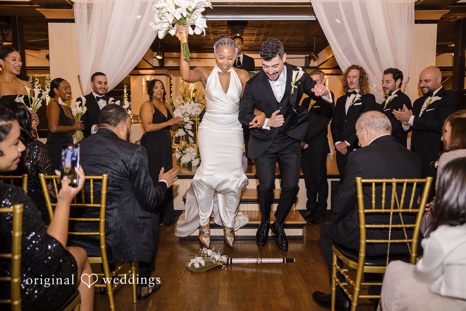 Patrick + Barbara Jean Bride and groom celebrating joyfully with their friends during the wedding reception.