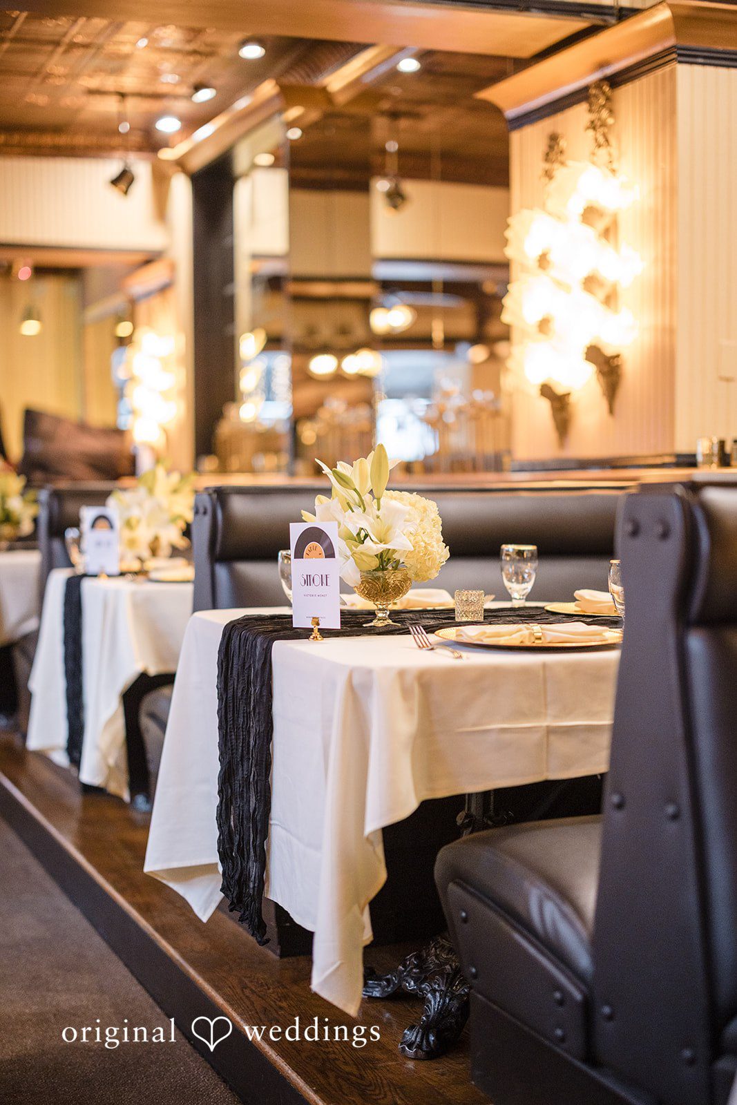 Patrick + Barbara Jean Decorated reception table setup inside a stylish restaurant venue.