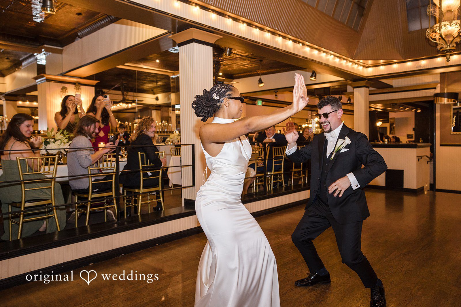 Patrick + Barbara Jean Wedding guests lifting the bride and groom into the air in celebration.