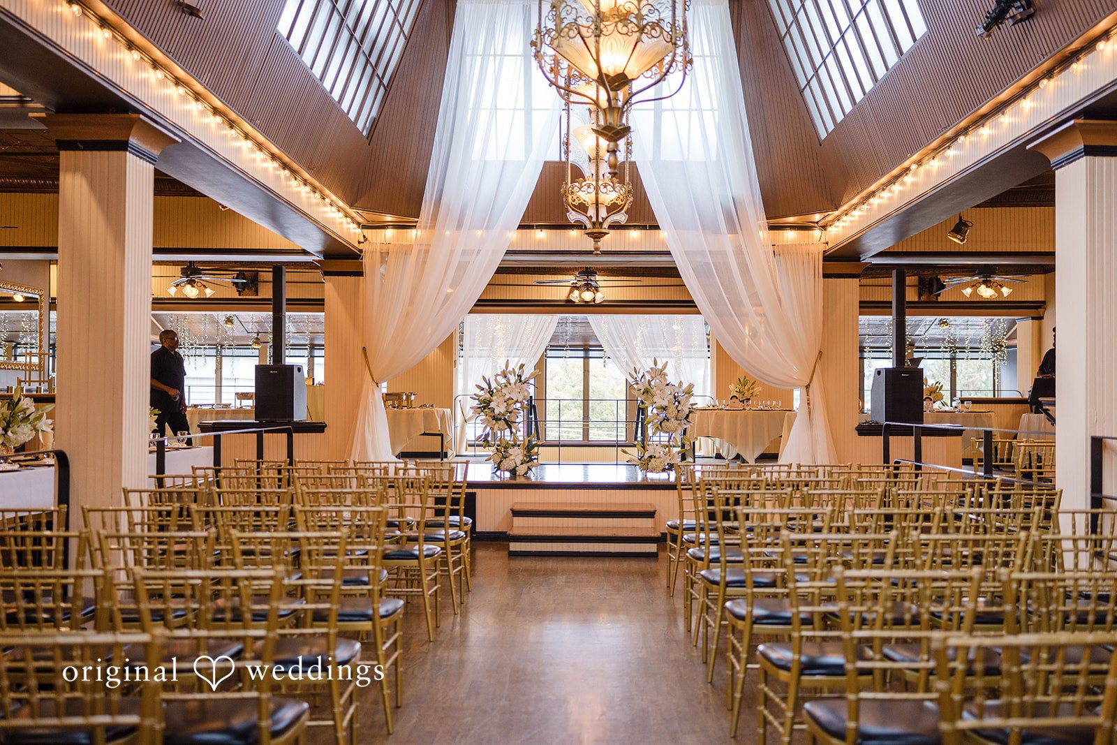 Patrick + Barbara Jean Elegant indoor wedding ceremony setup with gold chairs and white drapery