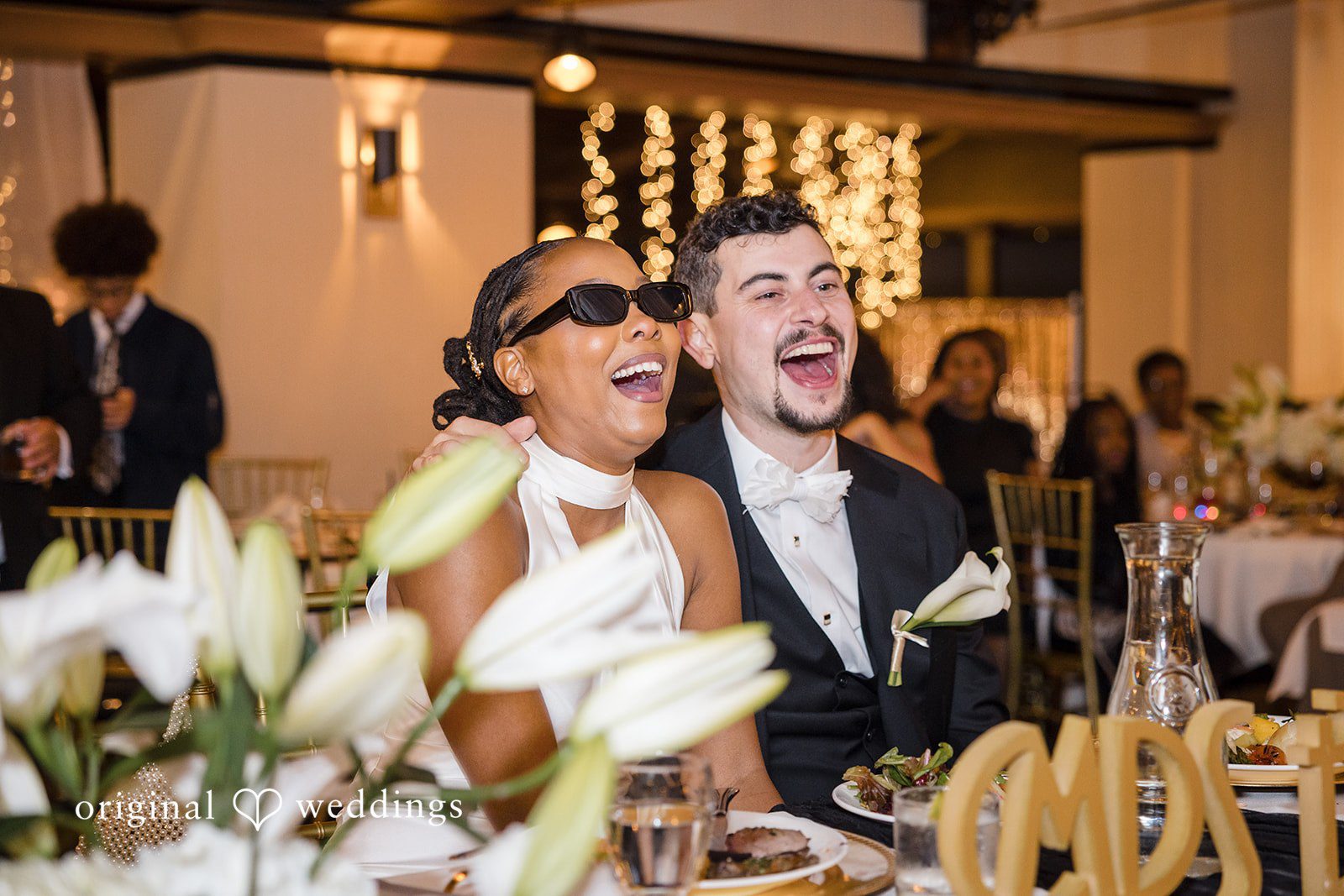 Patrick + Barbara Jean Bride and groom standing close together, smiling and embracing for a portrait.