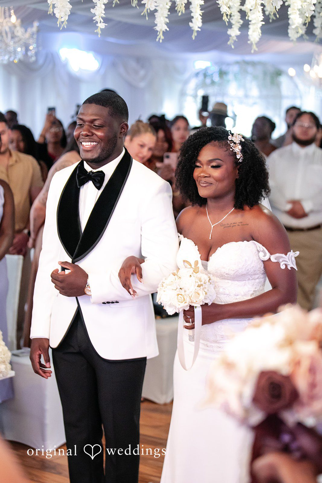 Whitchyna + Kevin Bride holding the groom’s arm during the wedding ceremony