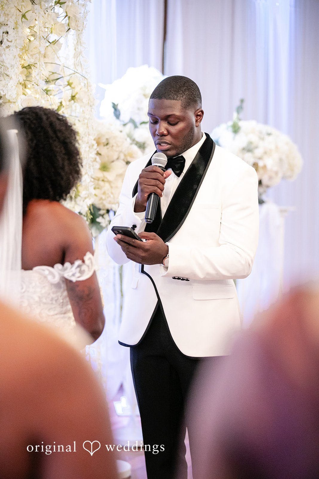 Whitchyna + Kevin Groom reading a heartfelt note during wedding ceremony