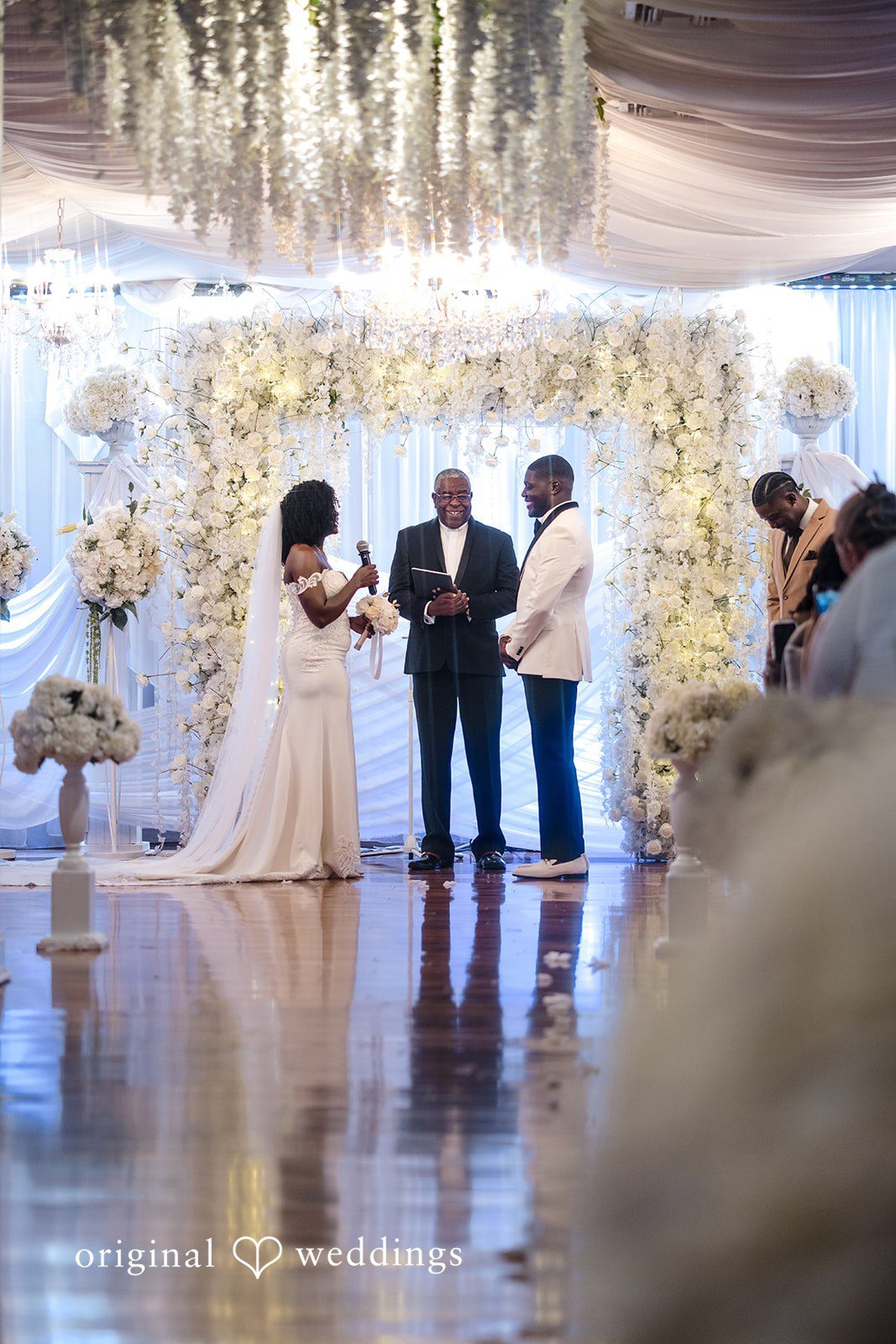 Whitchyna + Kevin Bride speaking into microphone during wedding ceremony