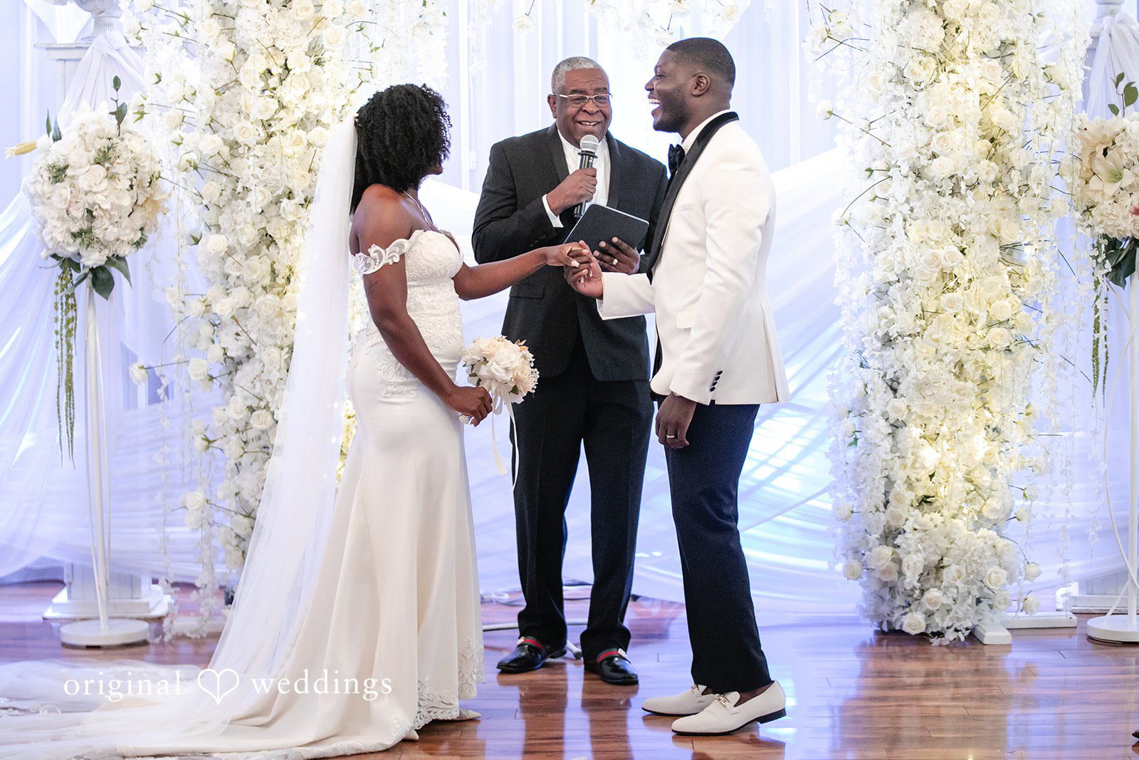 Whitchyna + Kevin Bride and groom holding hands during ceremony