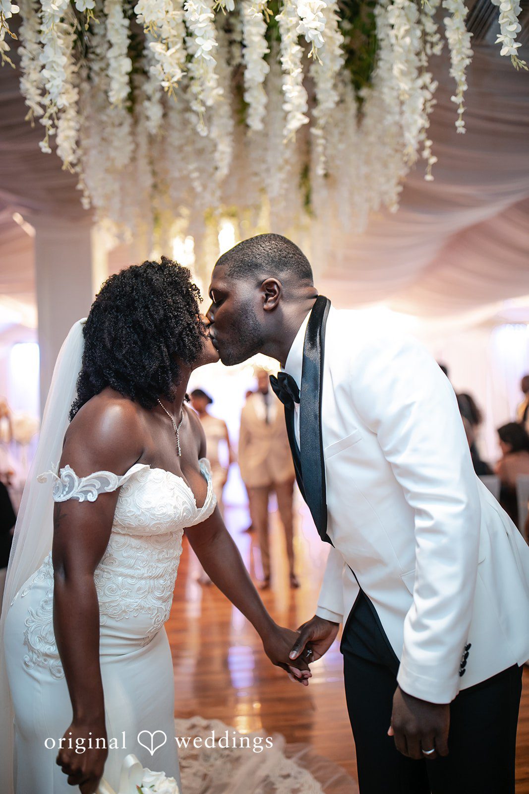 Whitchyna + Kevin Newlyweds sharing kiss after ceremony