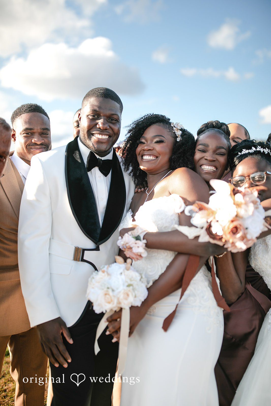 Whitchyna + Kevin Happy bride and groom smiling with their guests