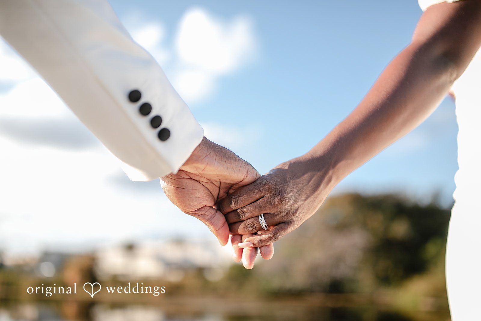 Whitchyna + Kevin Elegant close-up of couple holding hands with ring detail