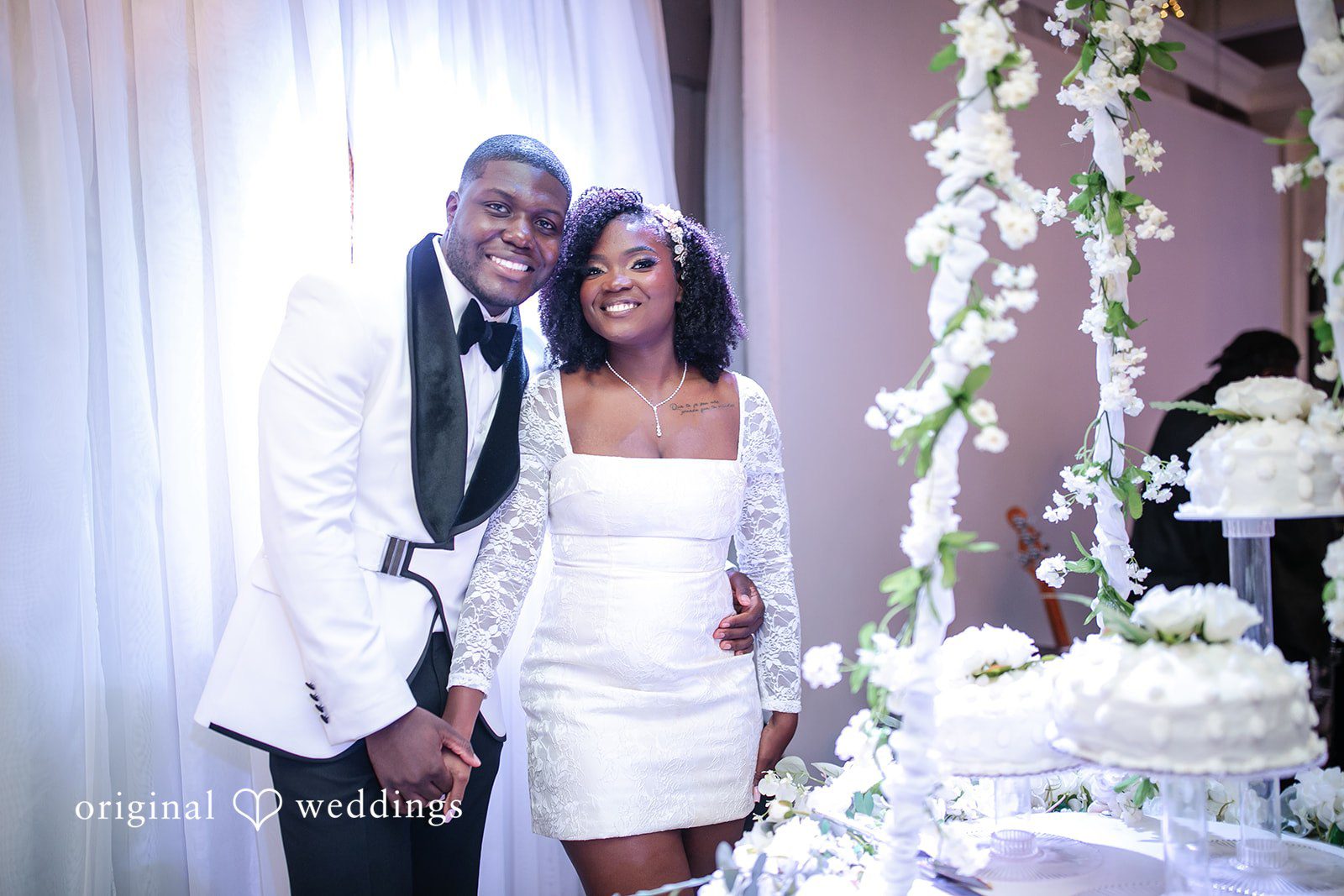Whitchyna + Kevin Bride and groom posing together before cake cutting at Imperial Design photographed by Original Weddings Orlando wedding photographer
