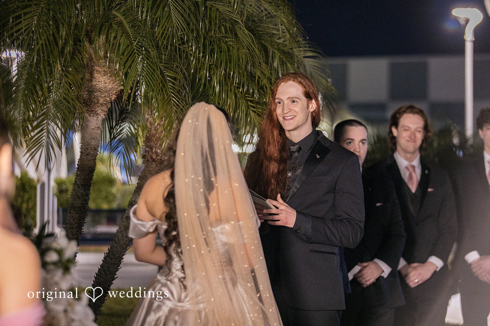 Groom reading a heartfelt note during wedding ceremony