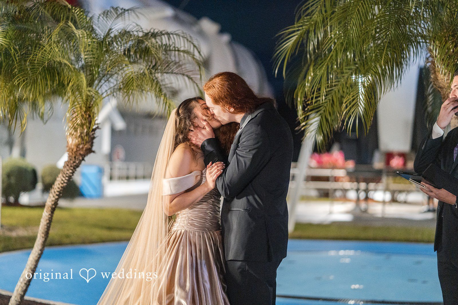 Romantic moment of bride and groom kissing after wedding ceremony