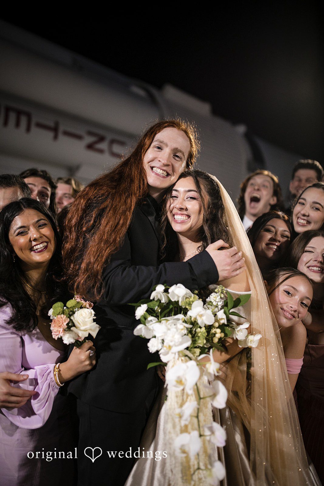 Bride, groom, and wedding guests celebrating at Kennedy Space Center