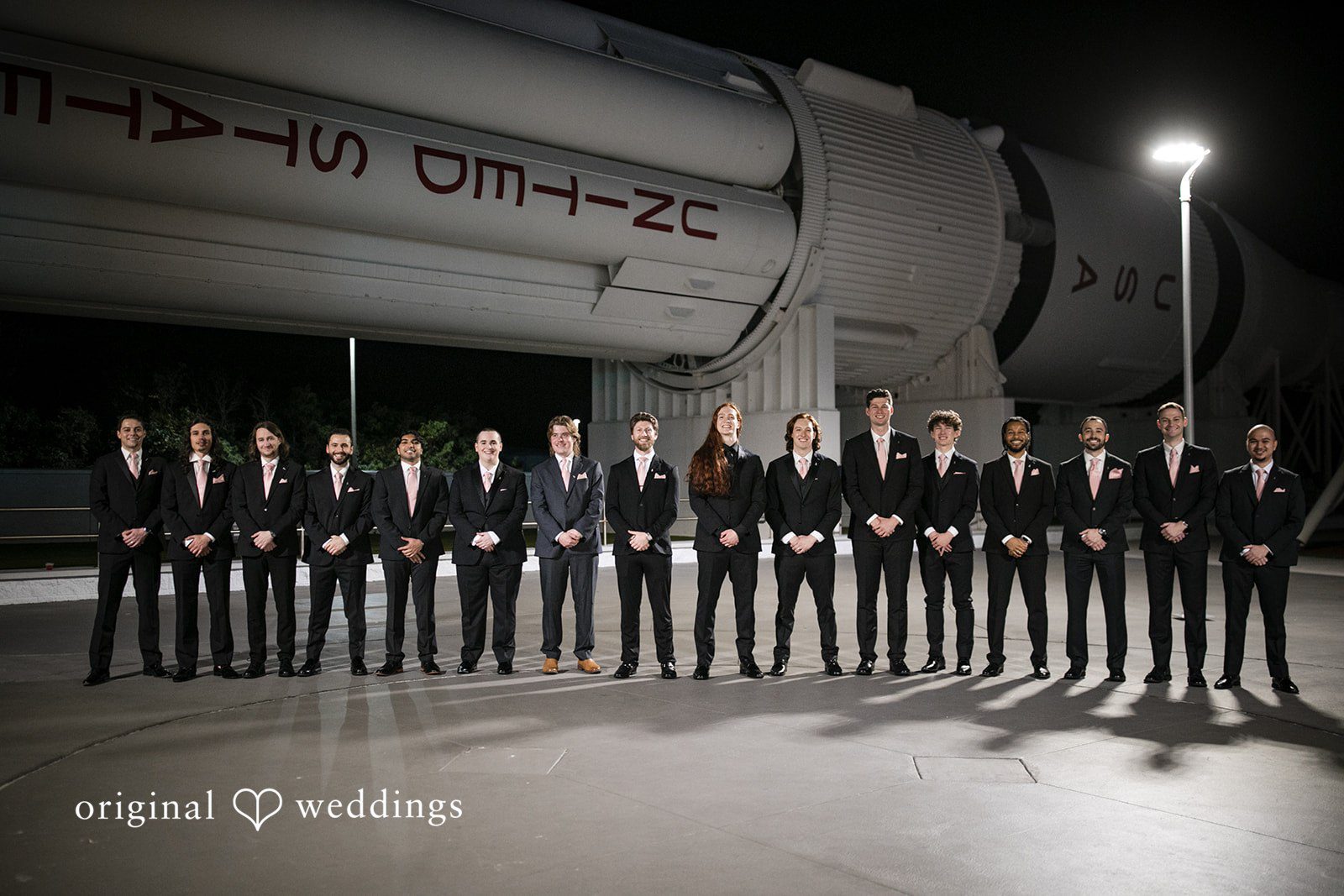 Groom with friends sharing joyful wedding moment