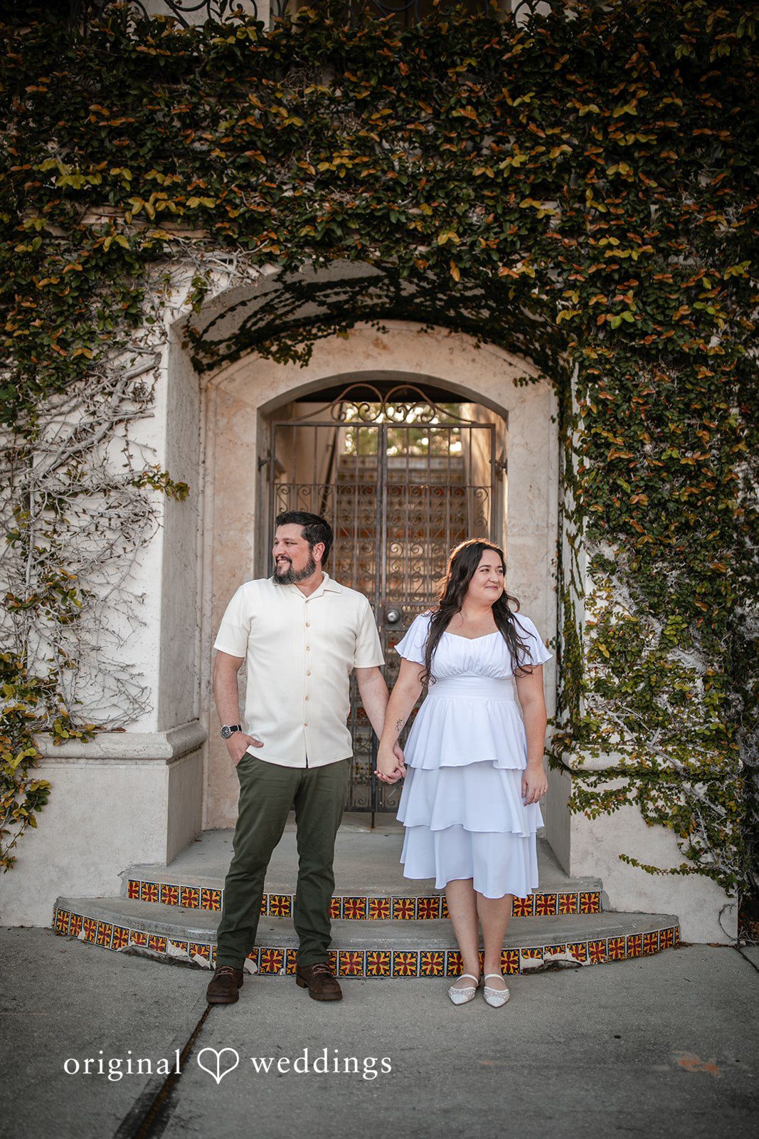 A portrait of the couple holding hands