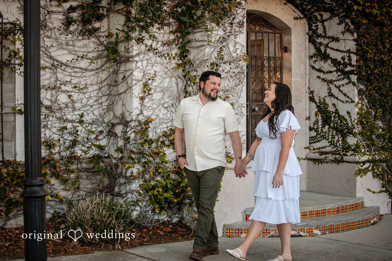 A joyful portrait of the couple taking a walk at the Kraft Azalea Gardens