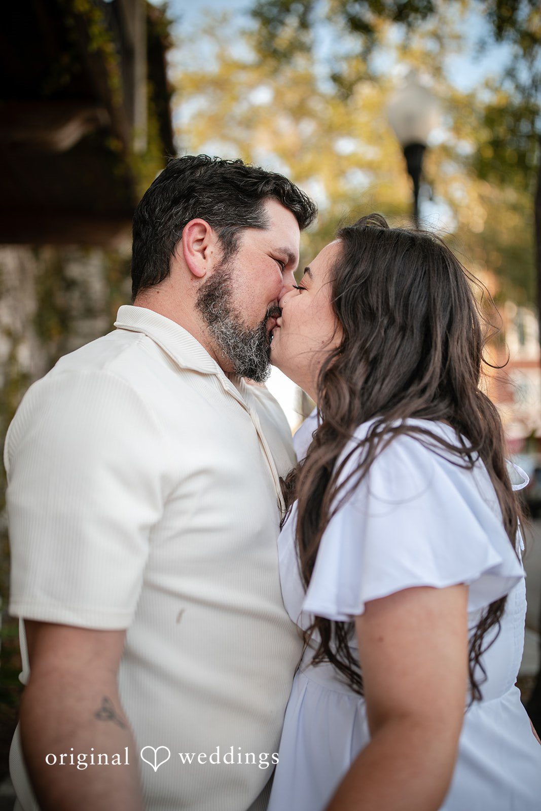 The couple shares a romantic kiss at the Kraft Azalea Gardens