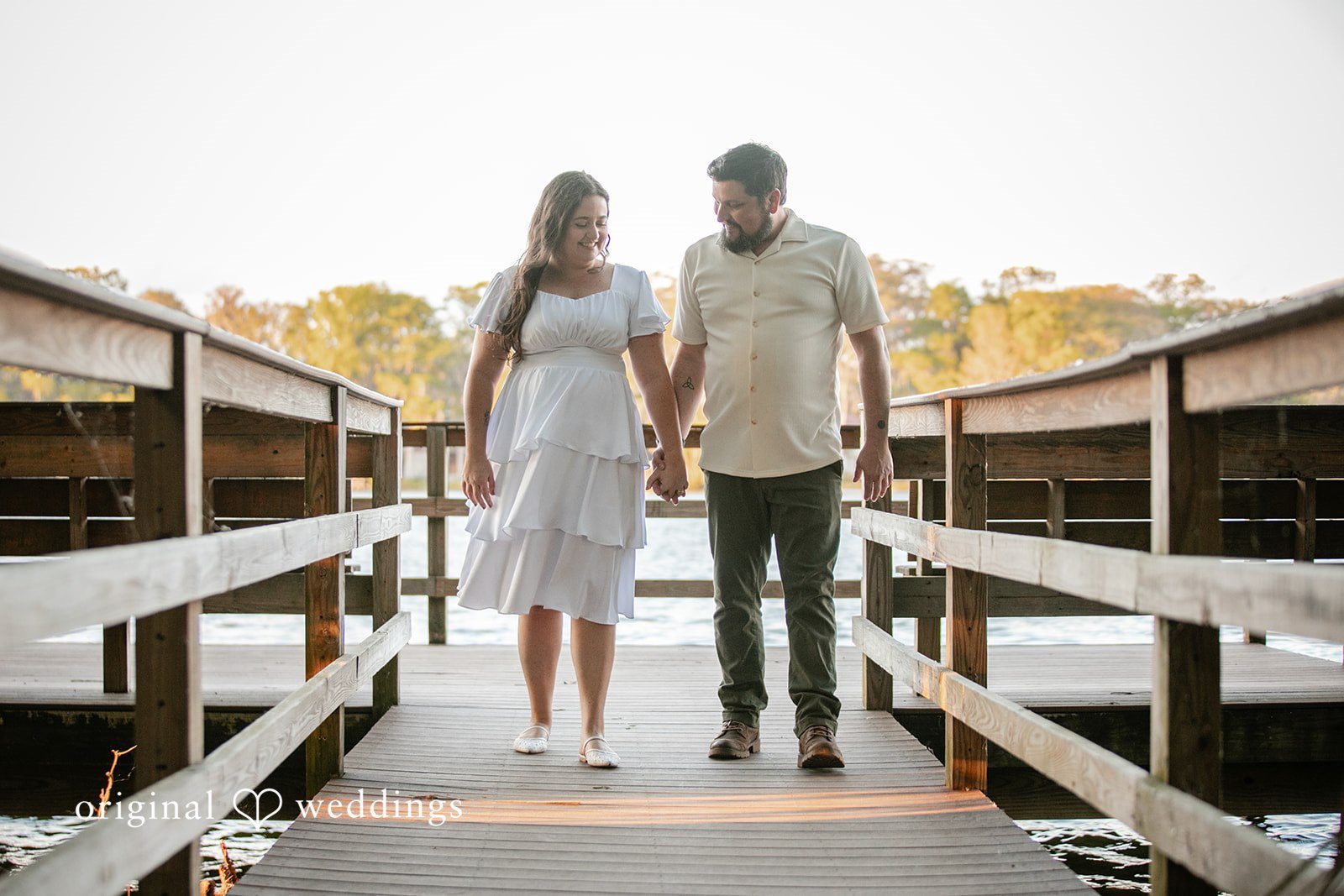 The couple walks through the trail
