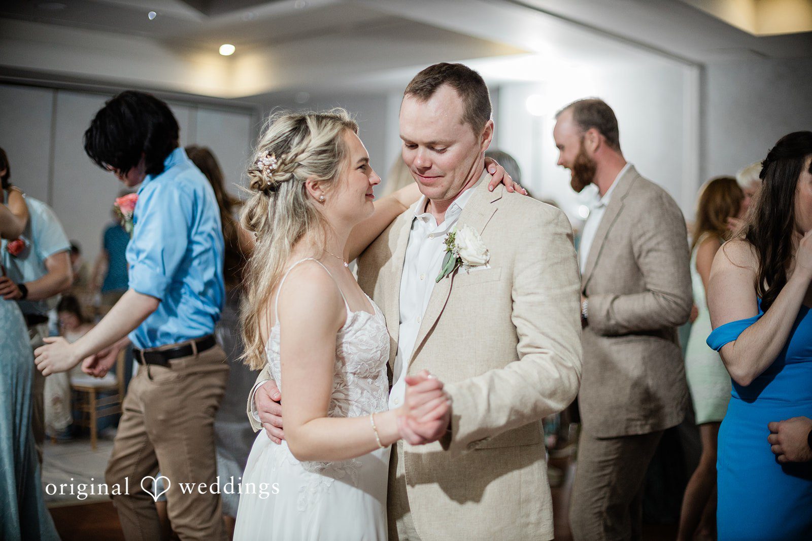 Ethan + Sydney Couple dancing with guests at wedding reception.