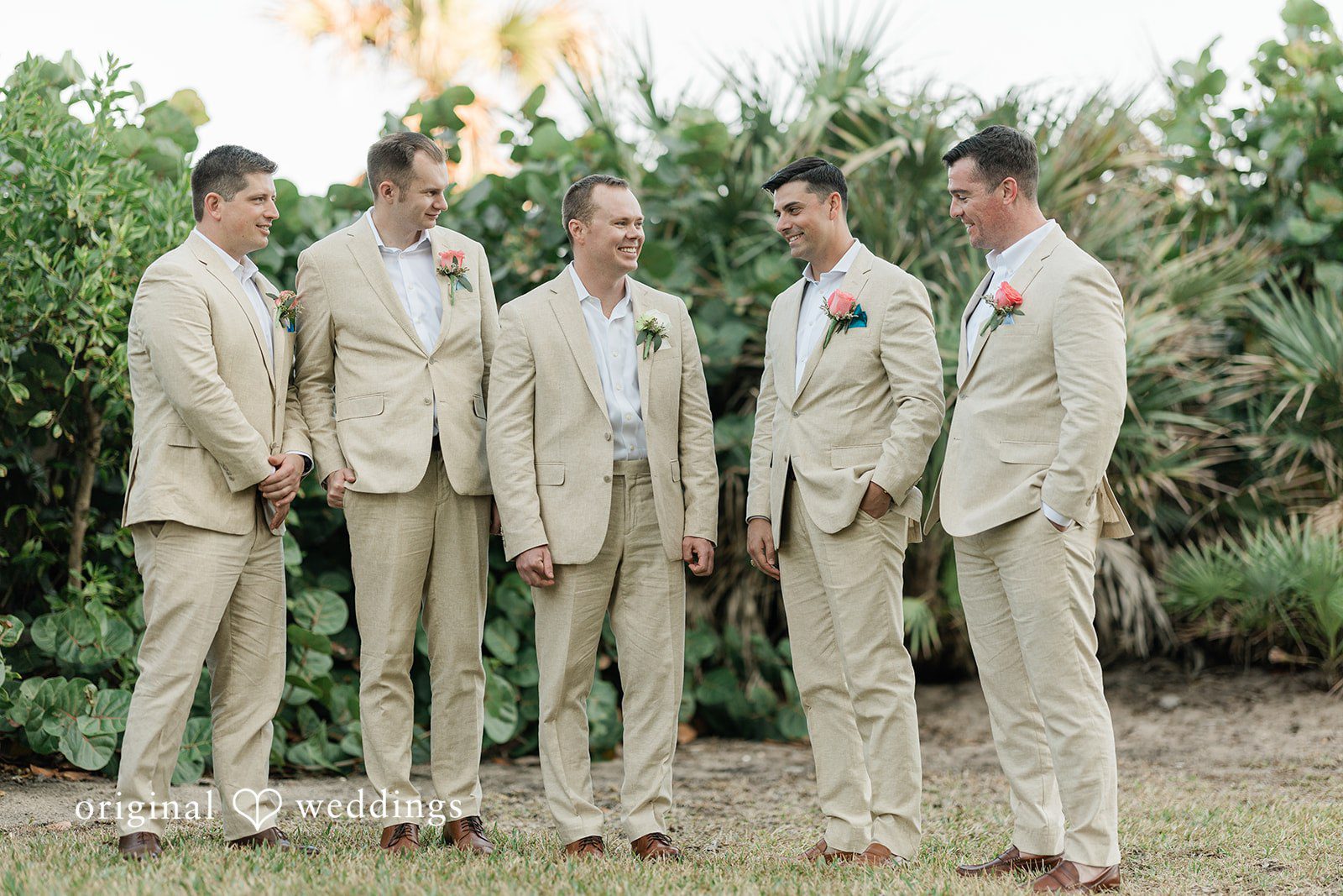 Ethan + Sydney Groomsmen standing together in light suits