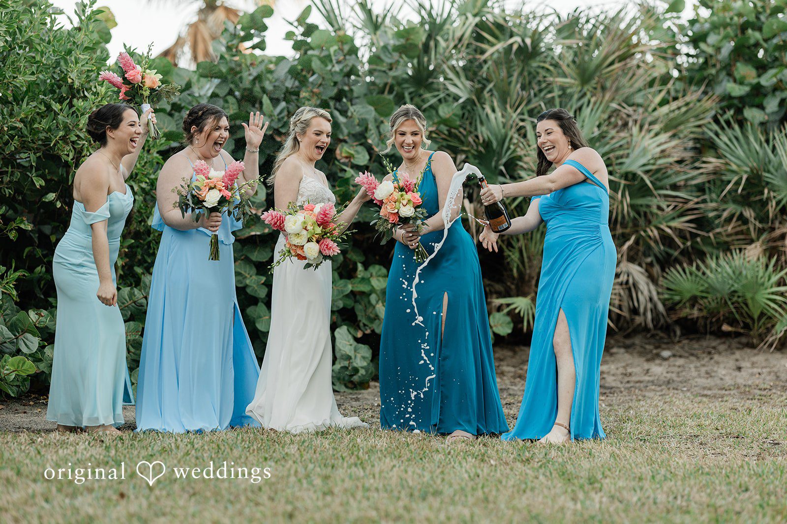 Ethan + Sydney Bridesmaids celebrating with bouquets outdoors.