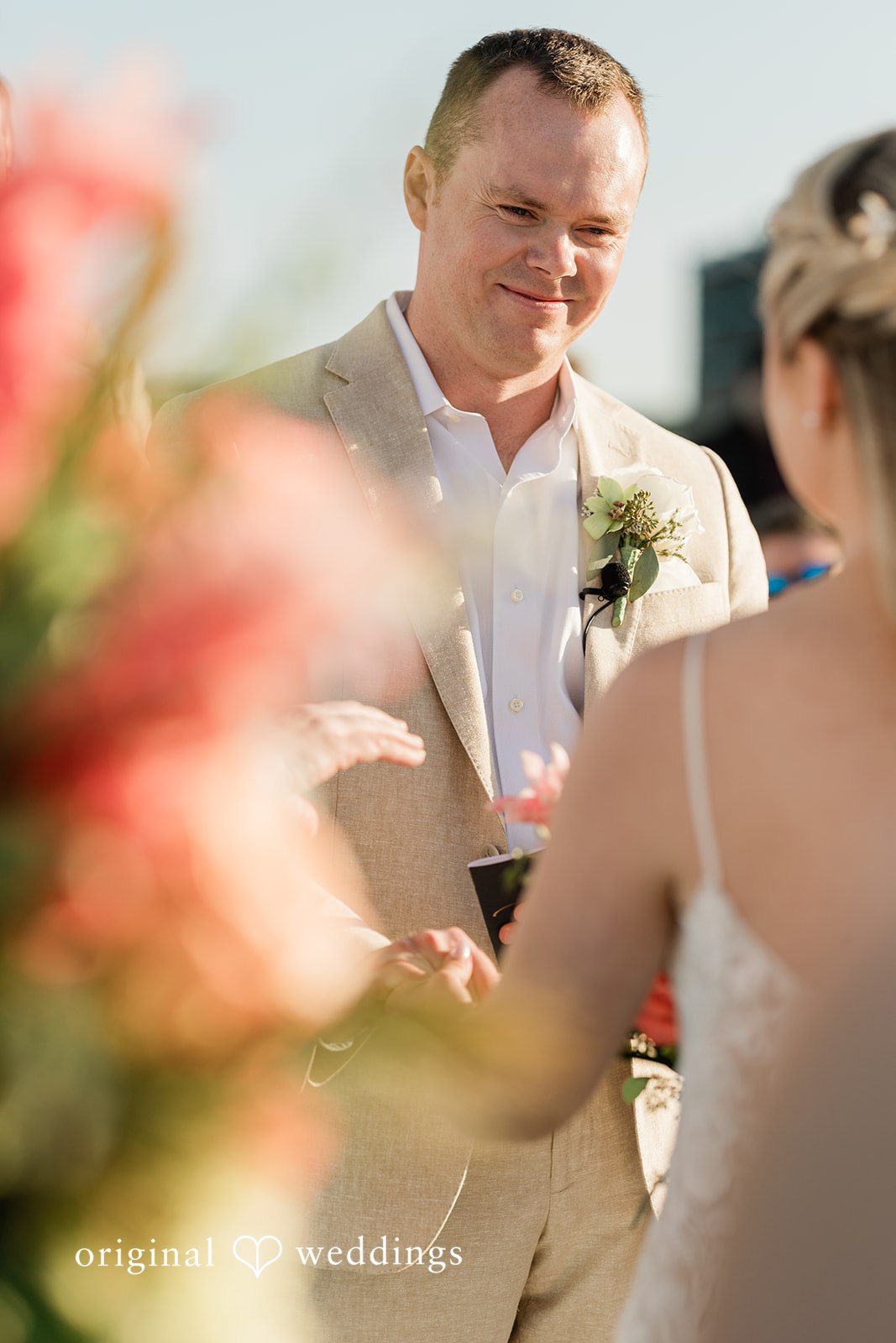 Ethan + Sydney Groom smiling during ceremony close-up.