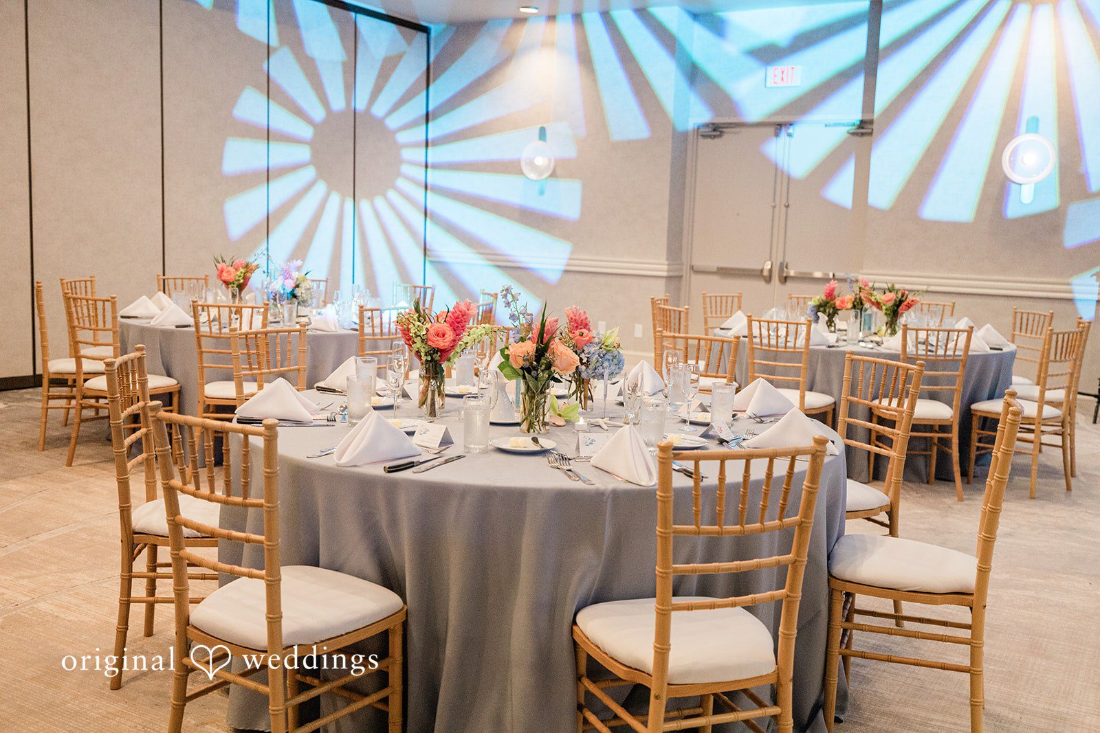 Ethan + Sydney Reception tables with gold chairs and floral decor at Marriott Hutchinson Island.